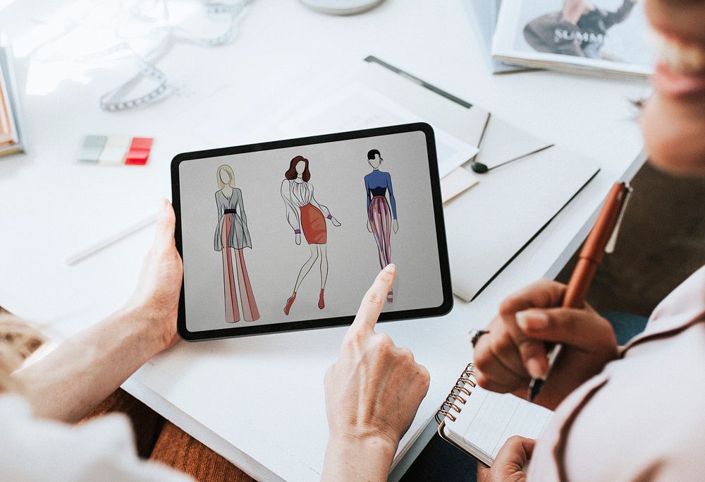 Fashion designer working on their design on a digital tablet