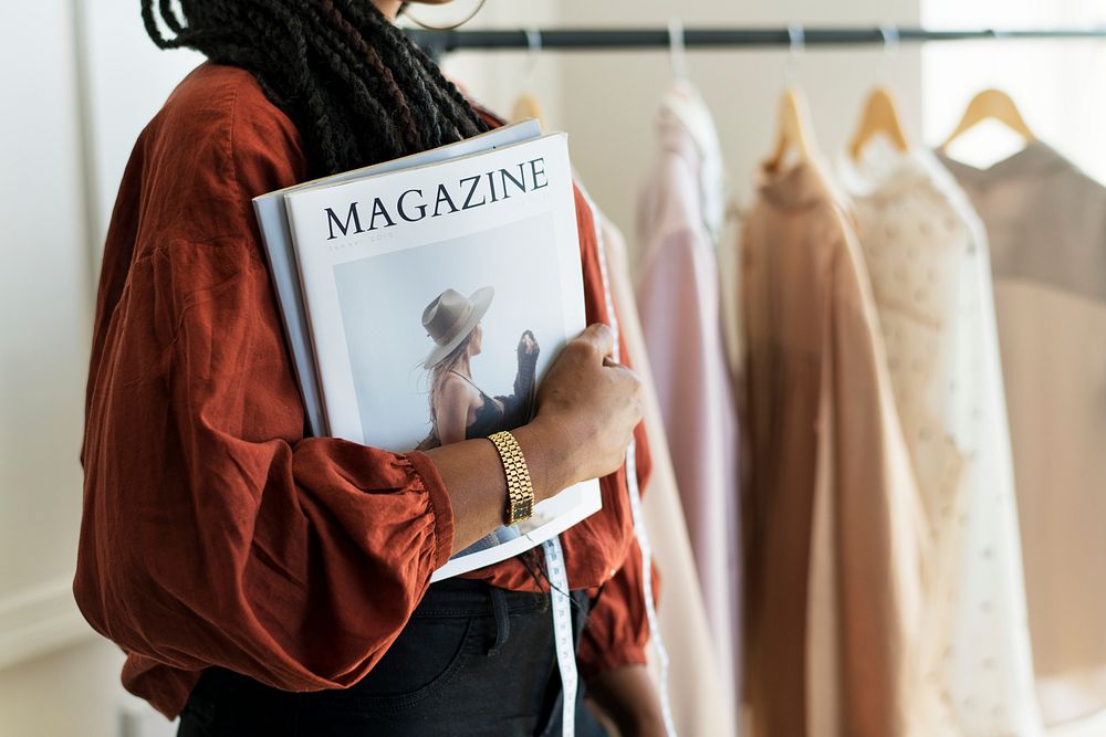 Young female designer holding a fashion magazine