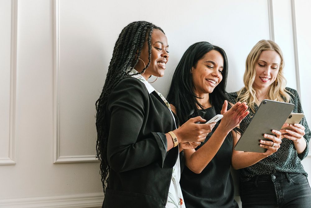 Happy diverse businesswoman using a digital tablet