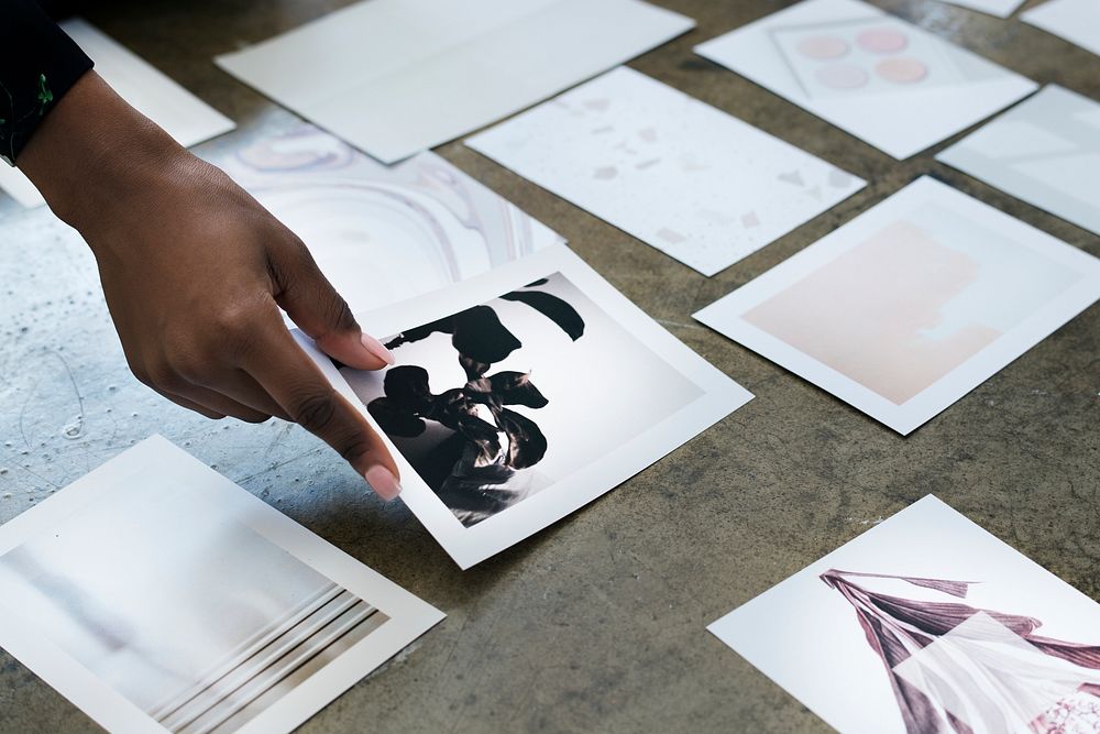 Designer laying out images on the floor