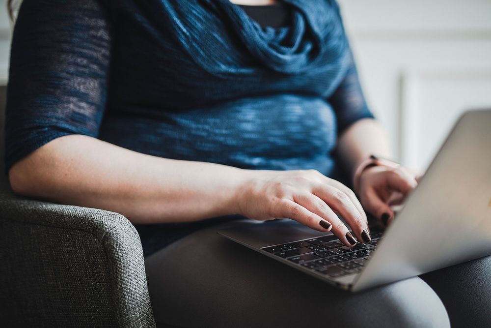 Woman typing on her laptop