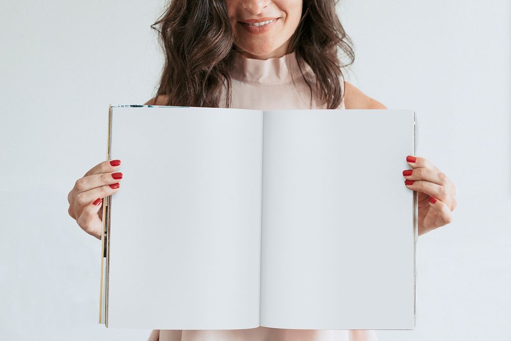Happy woman holding an empty notebook