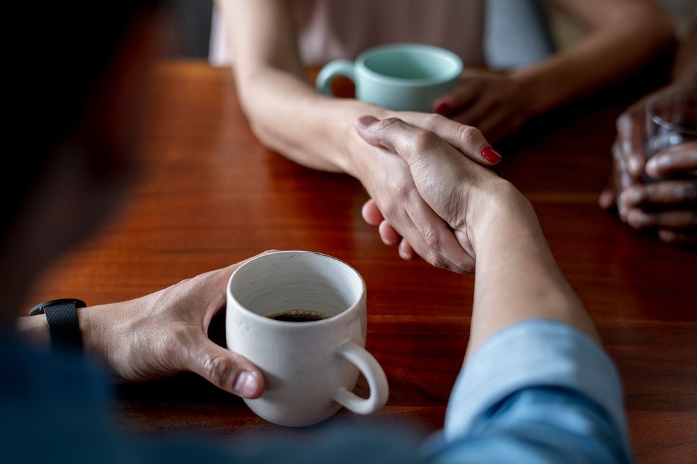 Partner shaking hands in a cafe