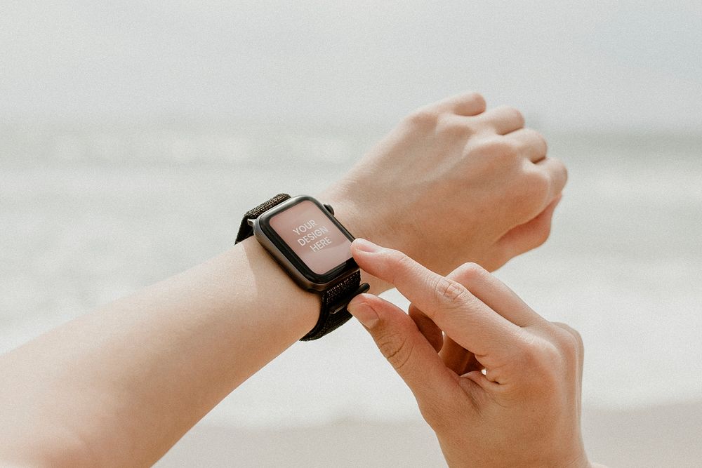 Woman checking her smartwatch mockup on the beach