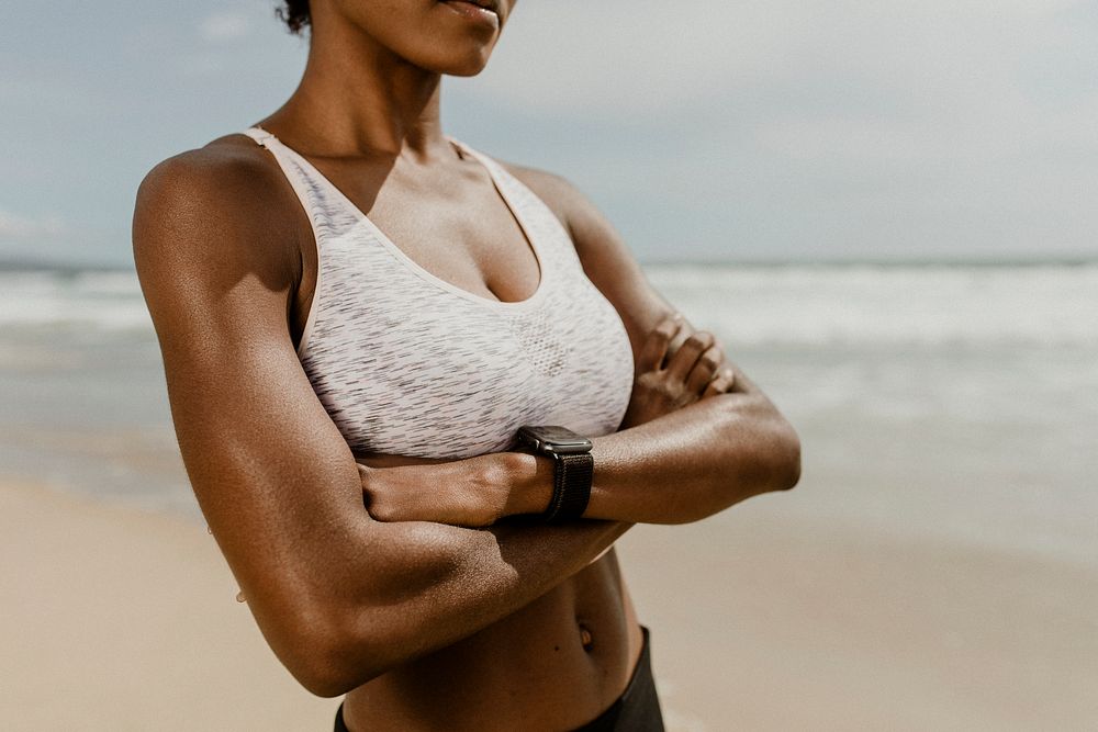 Black woman with arms crossed at the beach