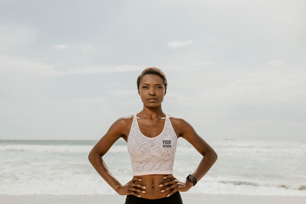 Confident sporty black woman on the beach