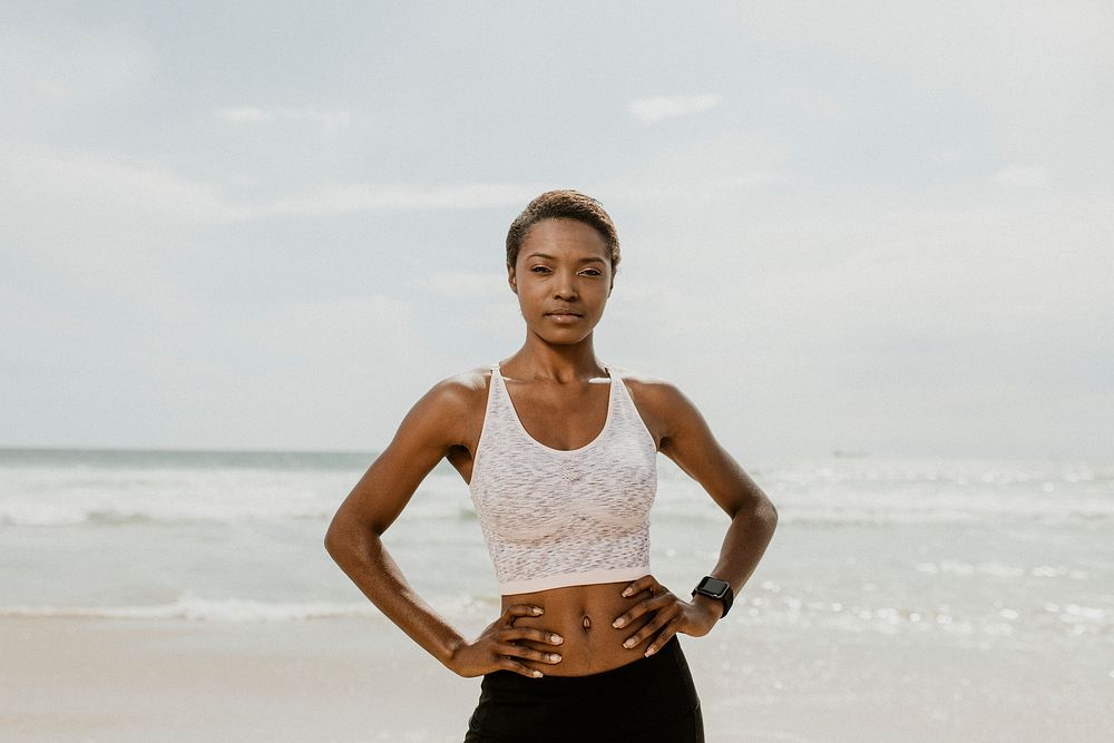 Confident sporty black woman on the beach
