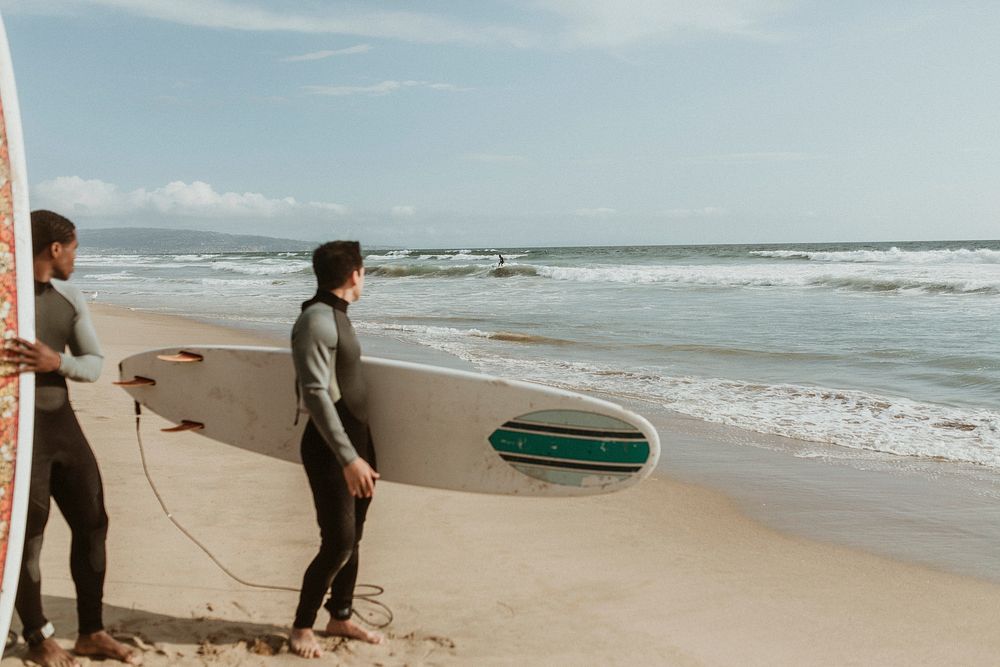 Men looking at a surfer at the beach