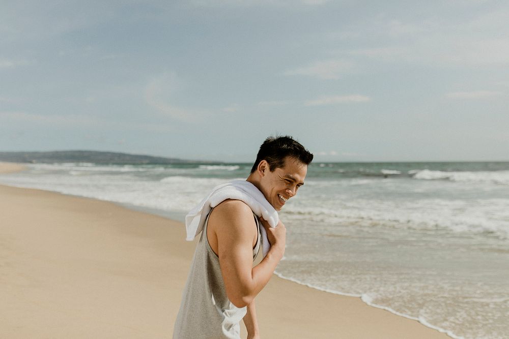 Happy sporty man on the beach