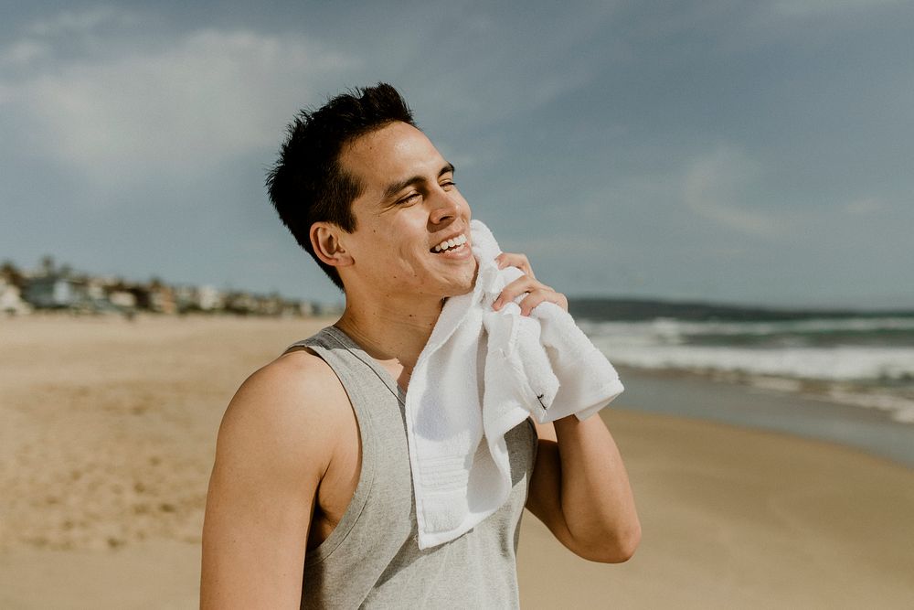 Man relaxing after workout on the beach