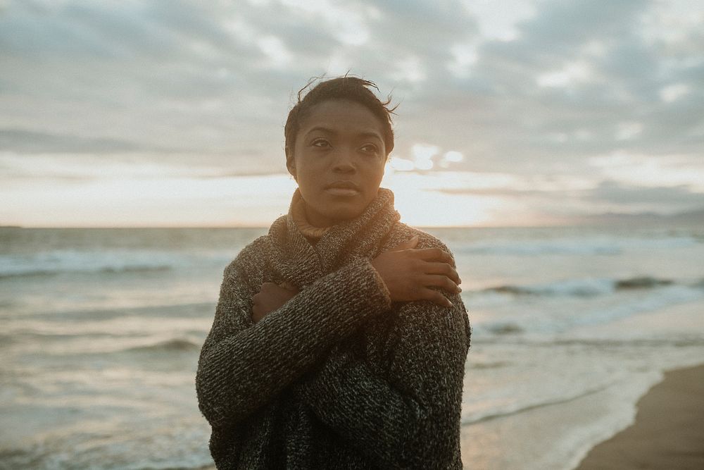 Black woman on the beach at sunset