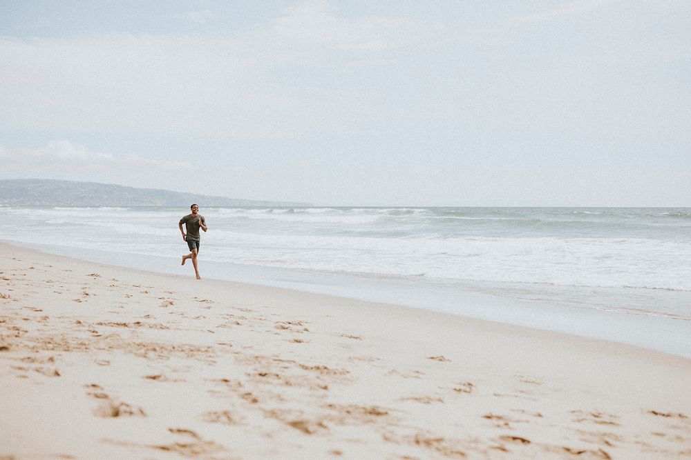 Black man running on the beach