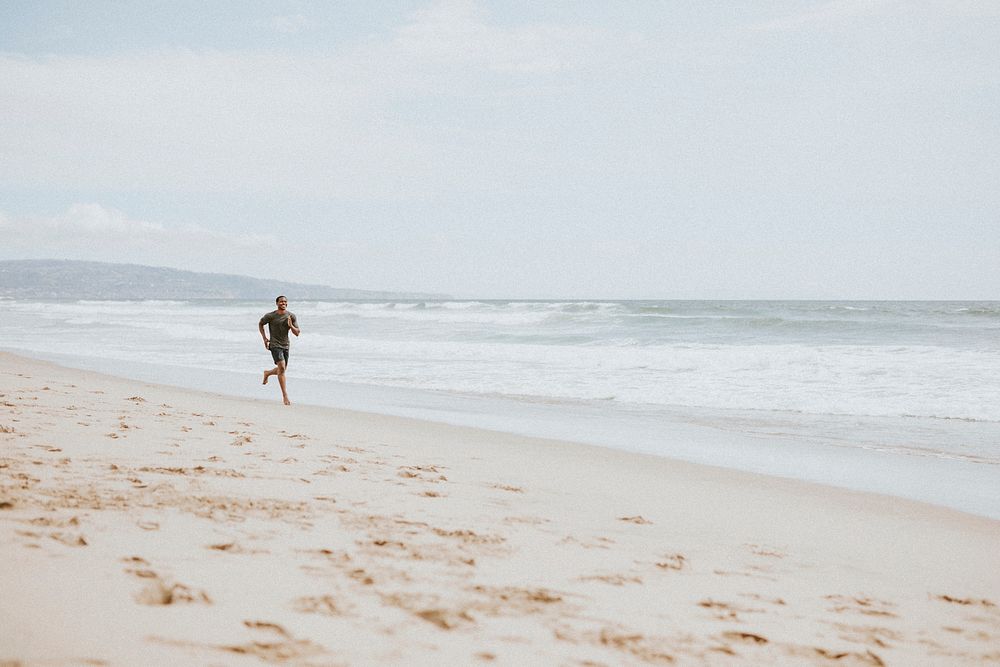 Black man running on the beach