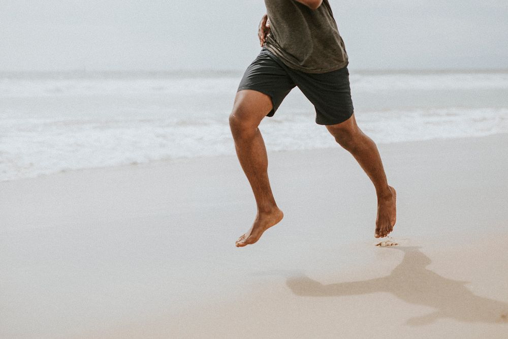 Black man running on the beach