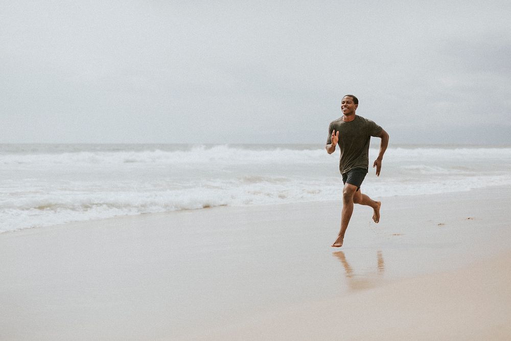 Black man running on the beach