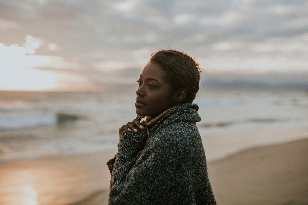 Black woman on the beach at sunset