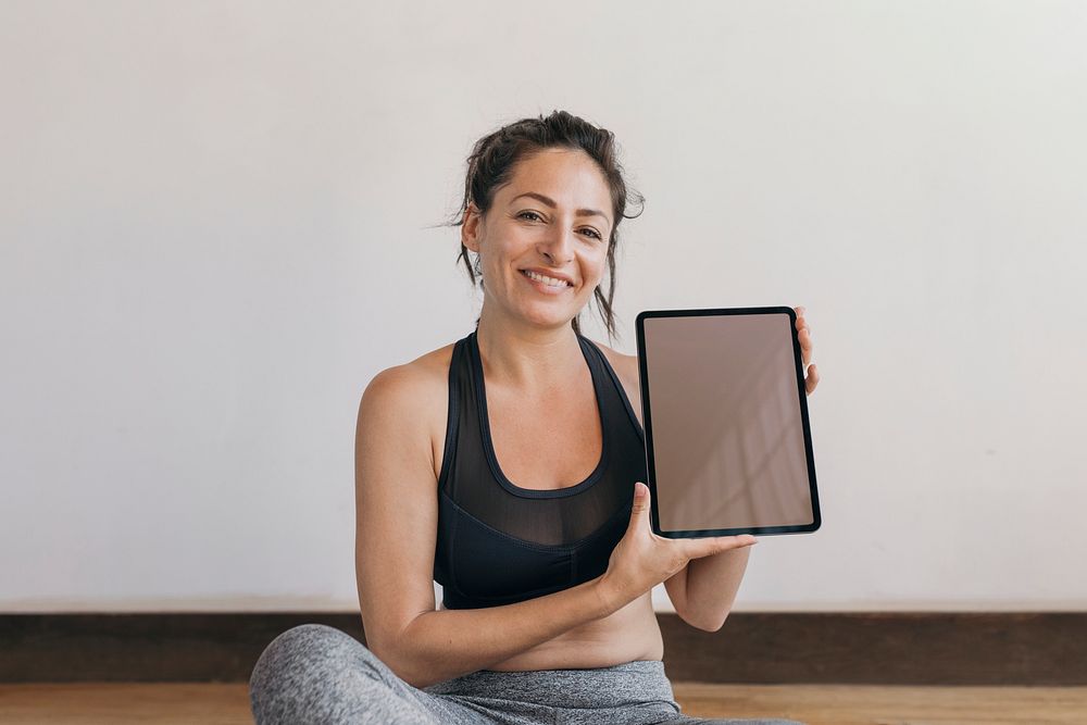 Yoga instructor showing a digital tablet mobile phone wallpaper