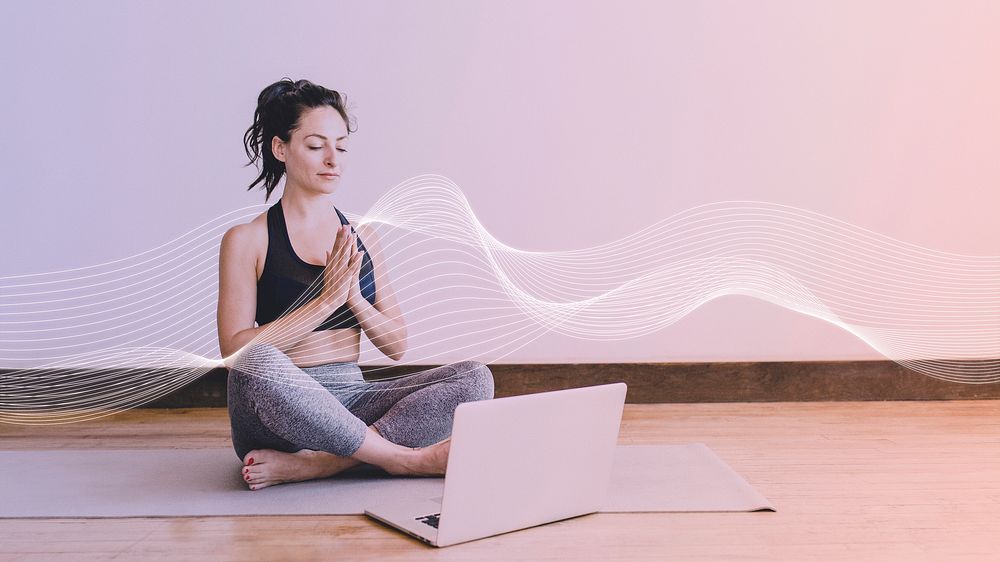 Active woman learning a yoga online via a laptop