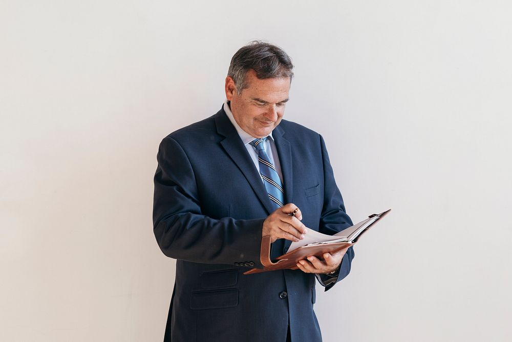 Businessman writing on a planner