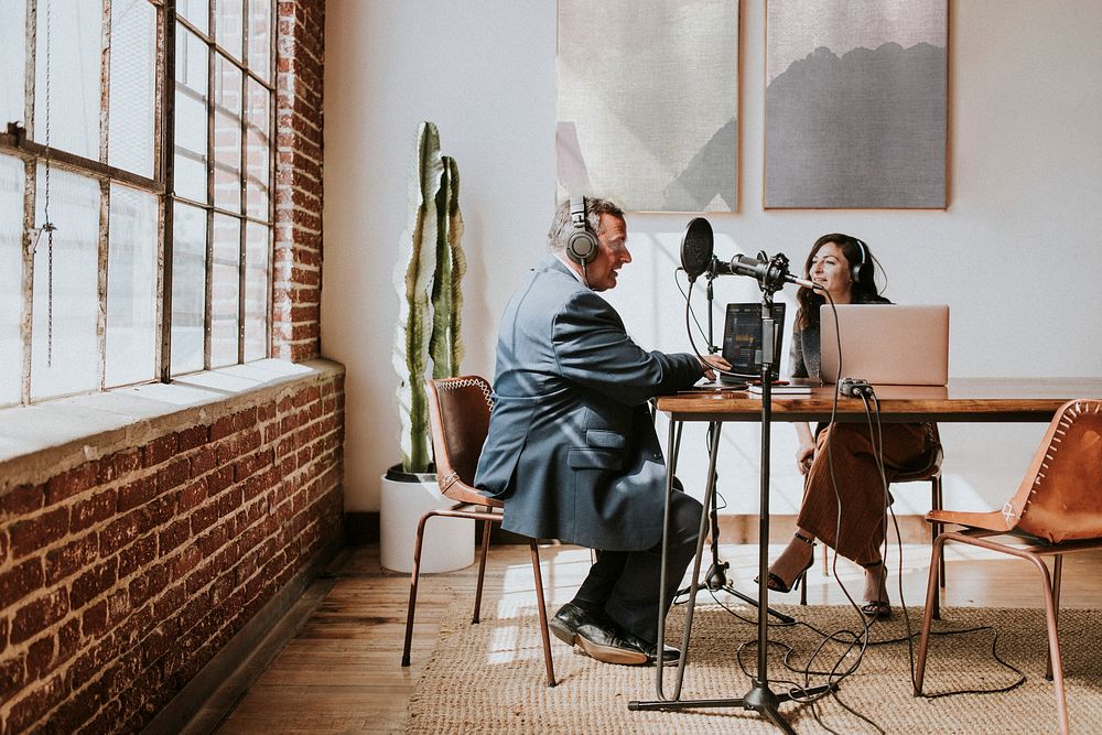 Female broadcaster interviewing her guest in a studio