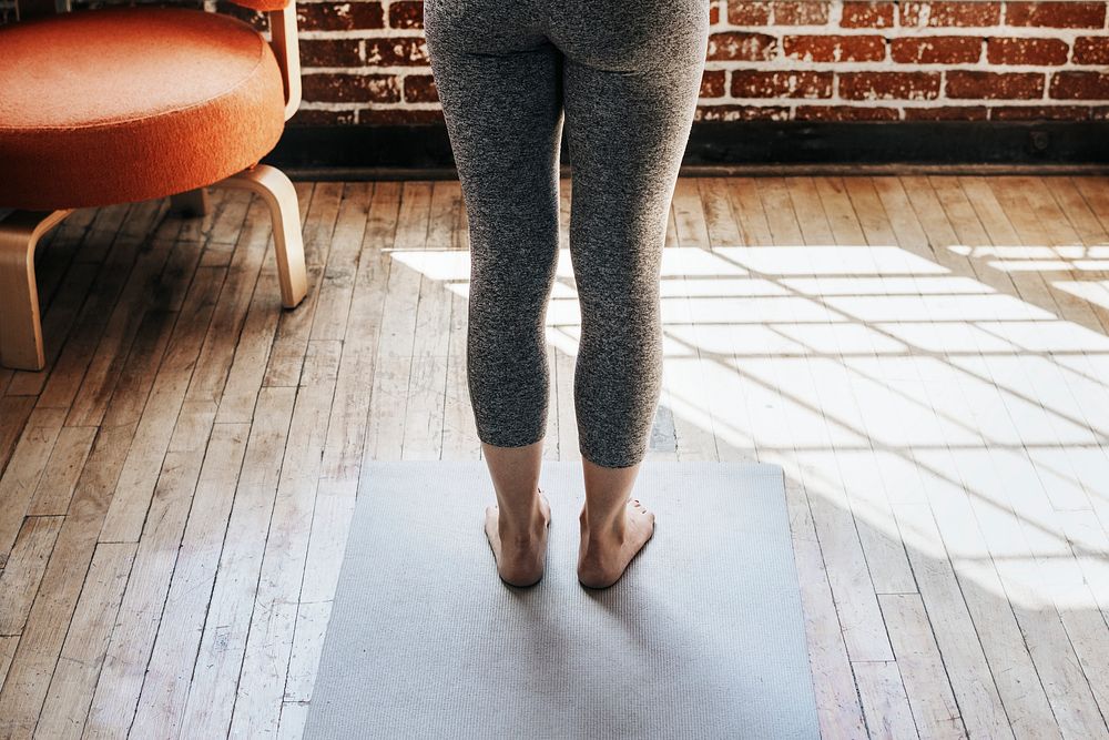 Active woman doing yoga in the room