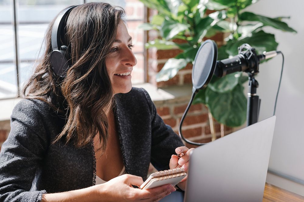 Female radio host broadcasting online in a studio