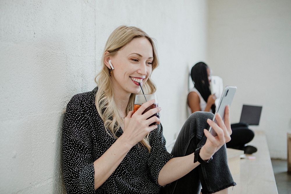 Cheerful woman listening to music from her phone