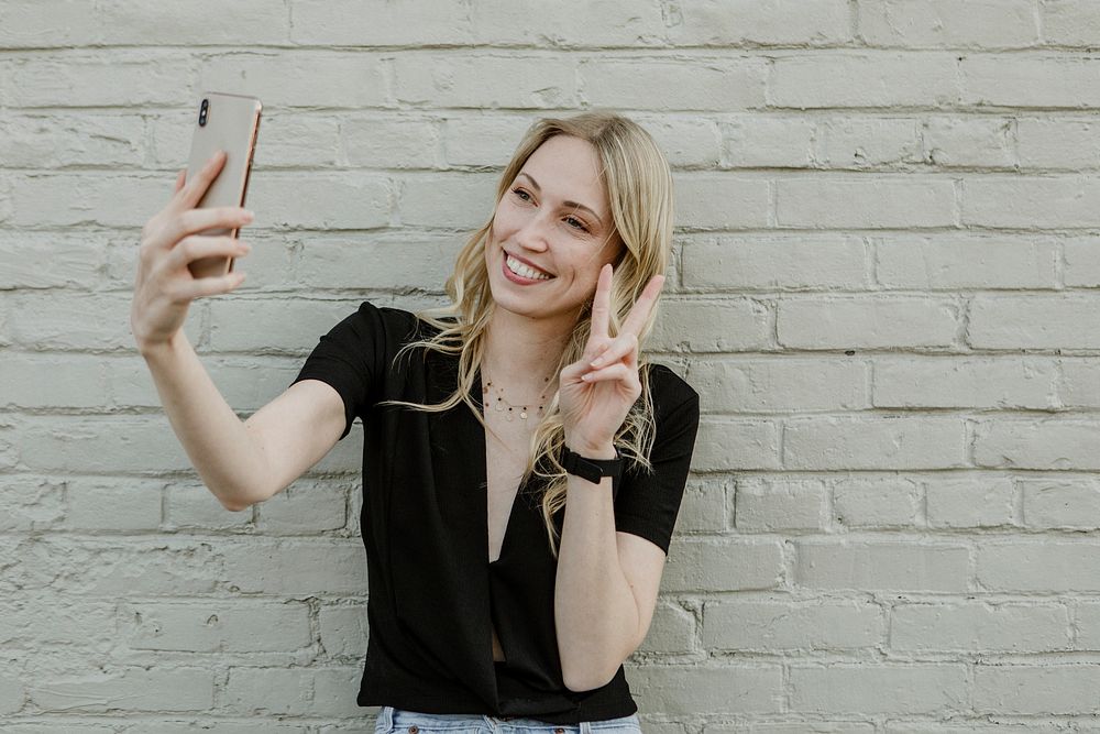 Cheerful blond woman taking a selfie