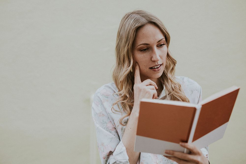 Thoughtful woman reading a book