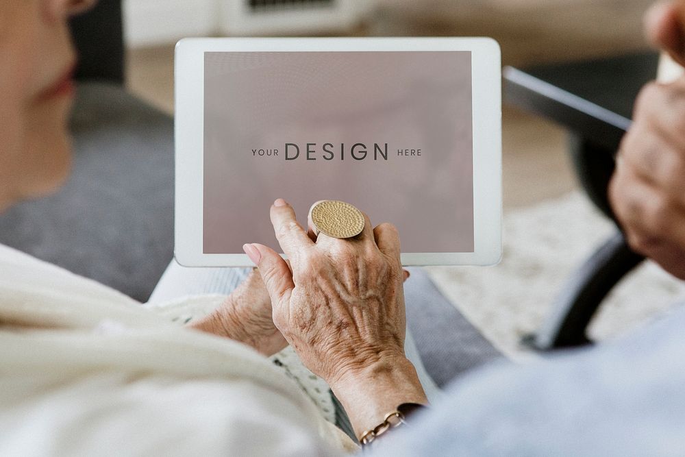 Elderly couple using a tablet on a couch