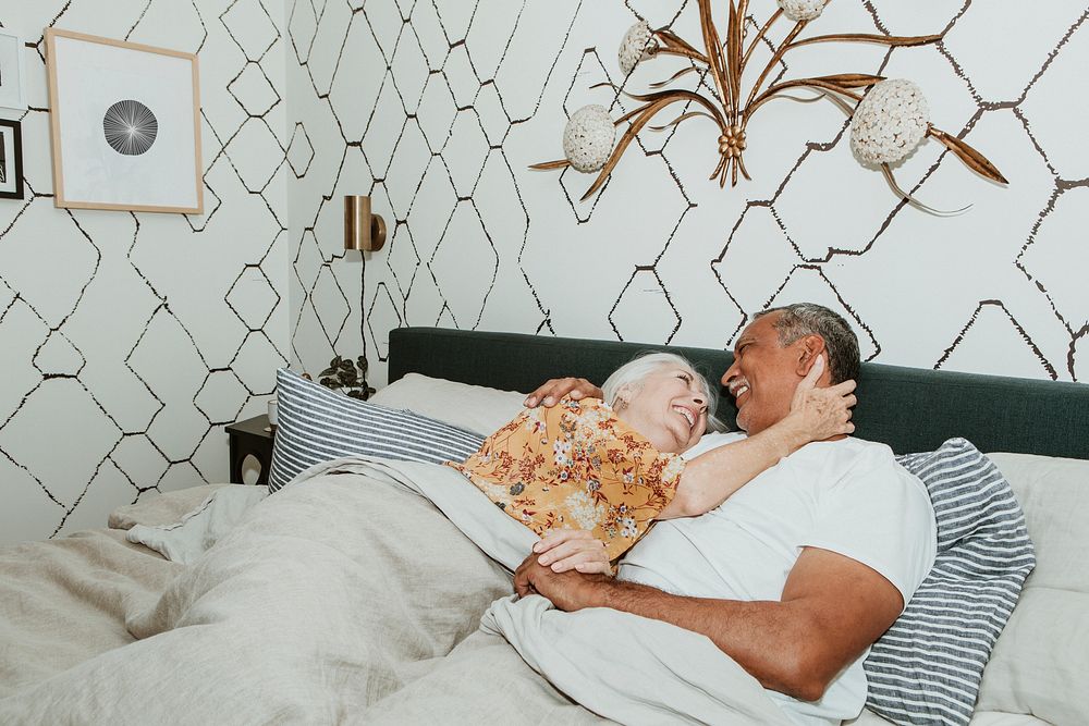 Cheerful elderly couple in a bed
