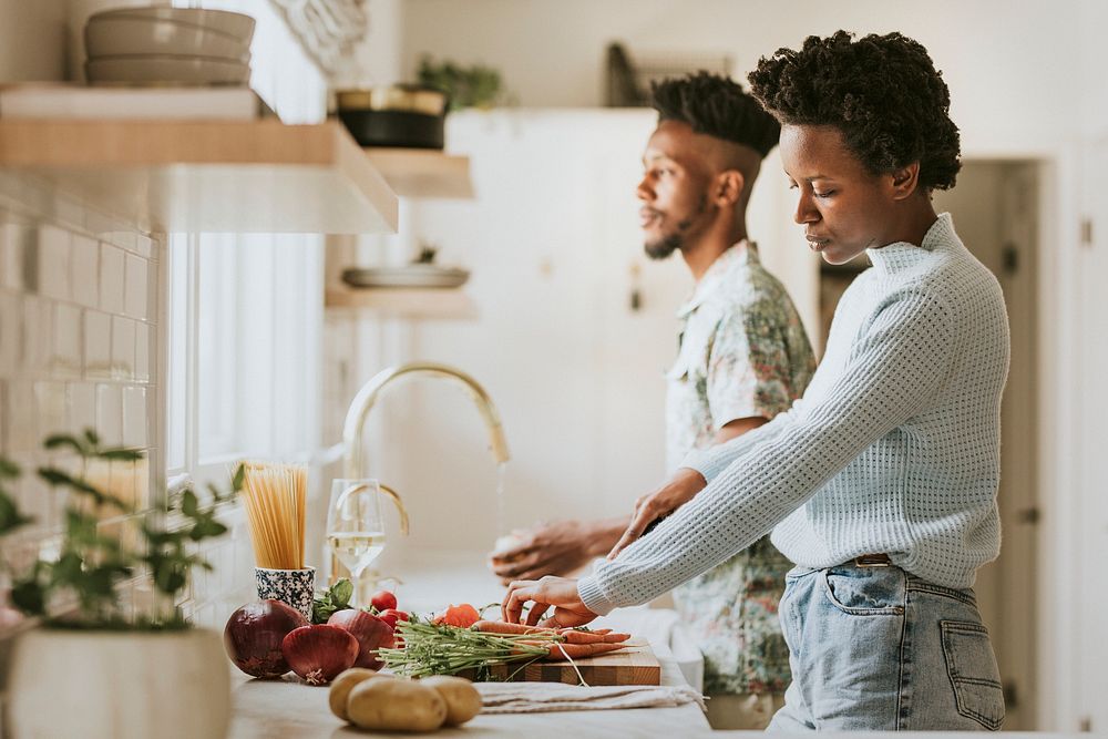 Black couple cooking in the kitchen