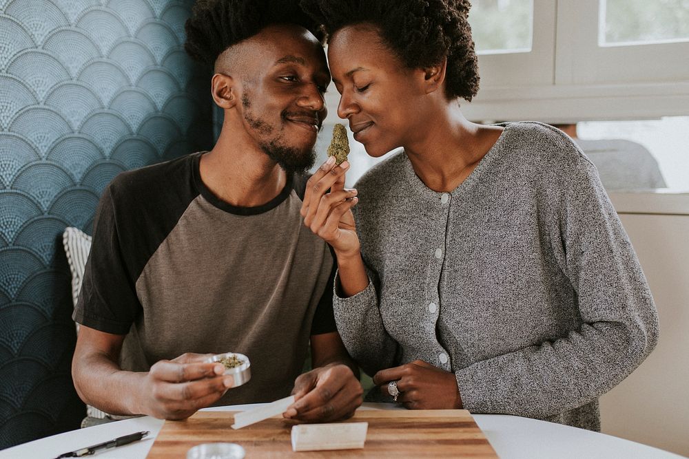 A couple rolling a joint