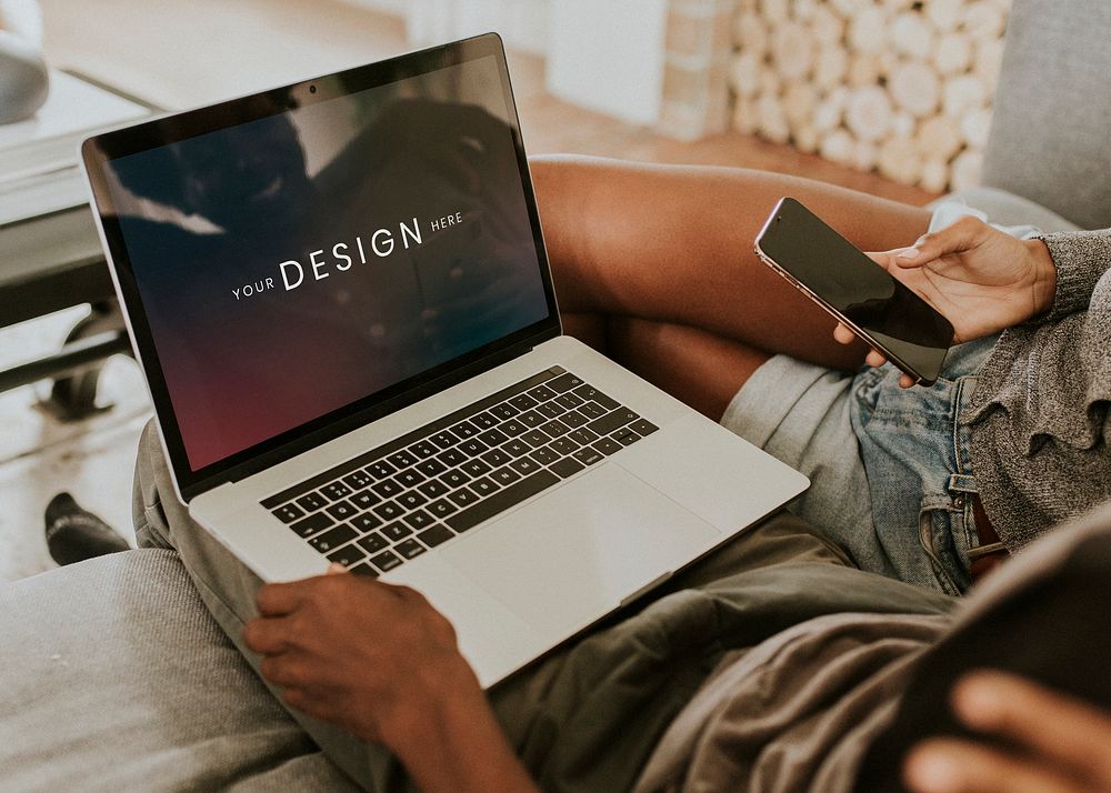 Black couple using a laptop and a mobile screen mockup