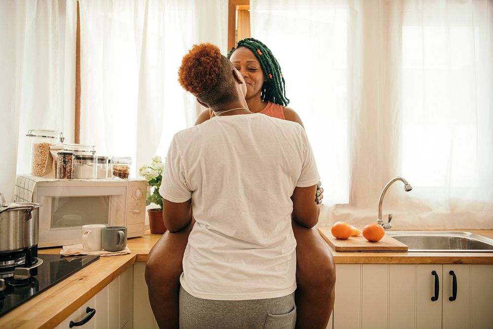 Happy gay couple kissing in the kitchen