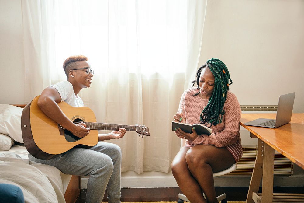 Happy lesbian couple making music together