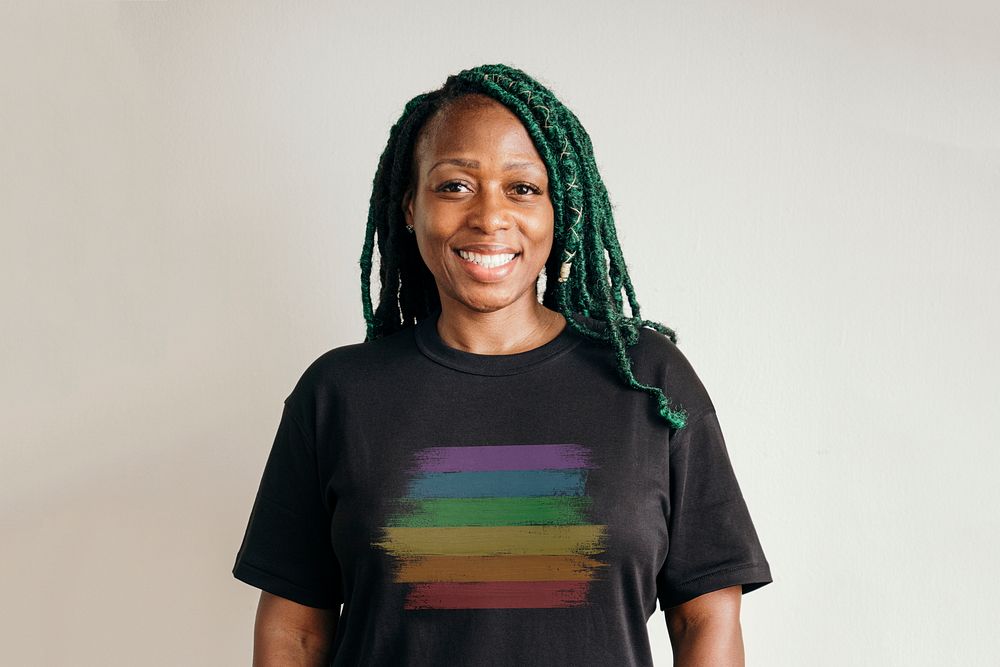 Black lesbian wearing a rainbow print t-shirt