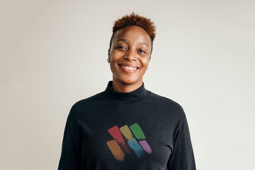 Black lesbian wearing a rainbow print turtleneck