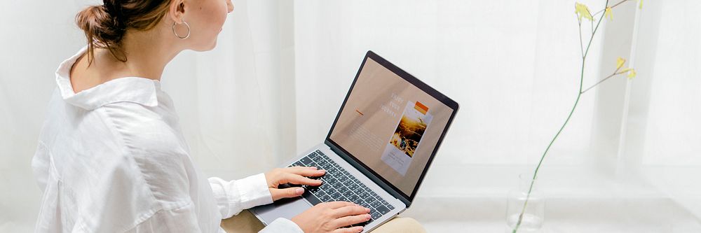 Woman using a laptop on a bean bag