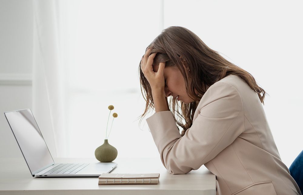 Depressed businesswoman overwhelming with her work