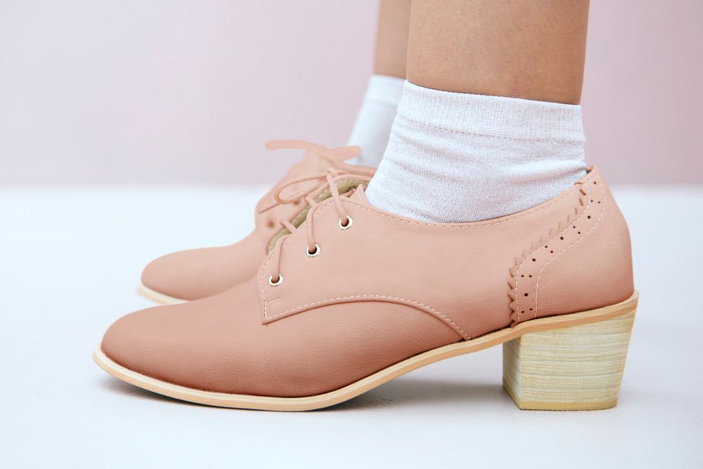 Woman in a nude pink oxford shoes