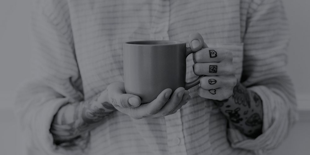 Tattooed woman with a cup of coffee