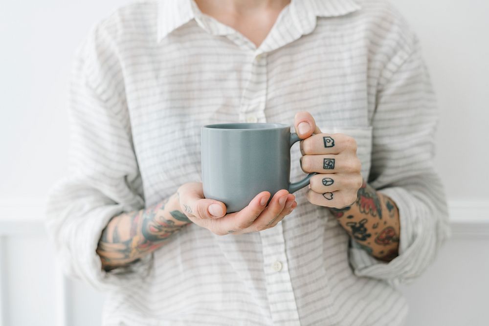 Tattooed woman with a cup of coffee