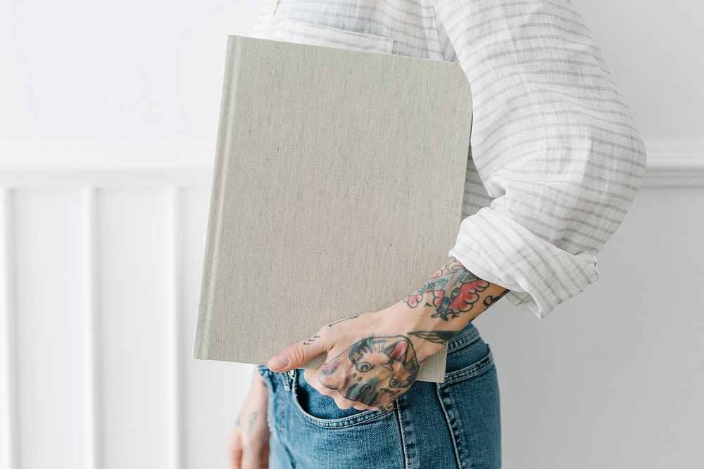Tattooed woman holding a book mockup