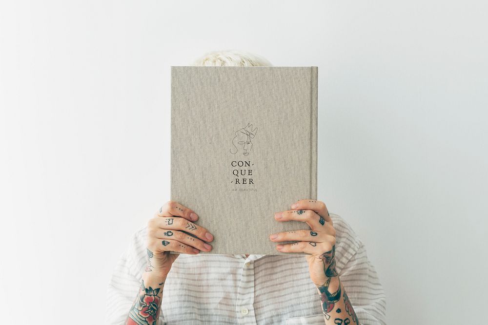 Tattooed woman holding a book mockup