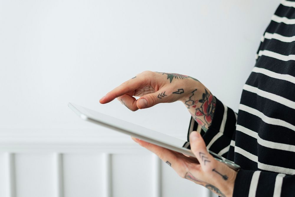 Tattoo woman using a tablet