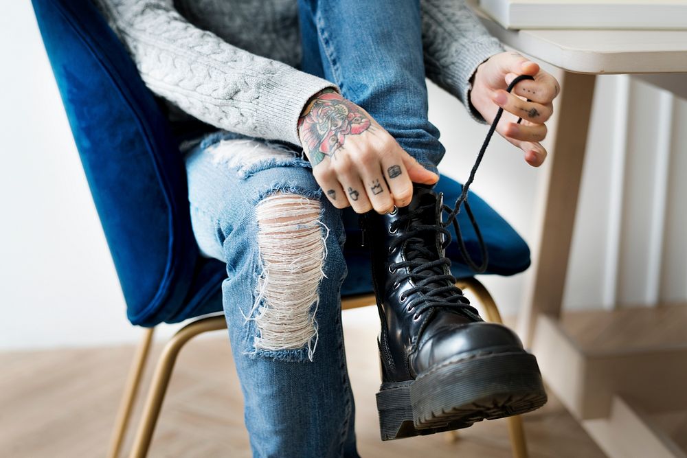Woman tying her shoelaces on a chair