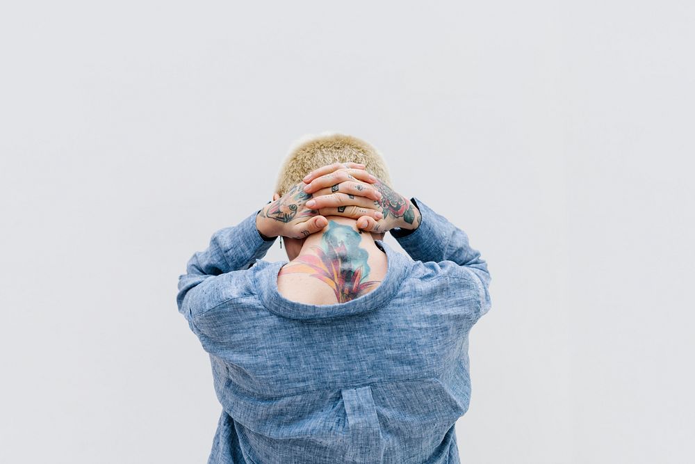 Cool tattooed woman in a blue linen shirt