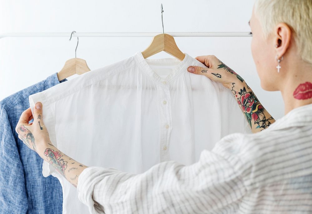 Woman looking at a white shirt