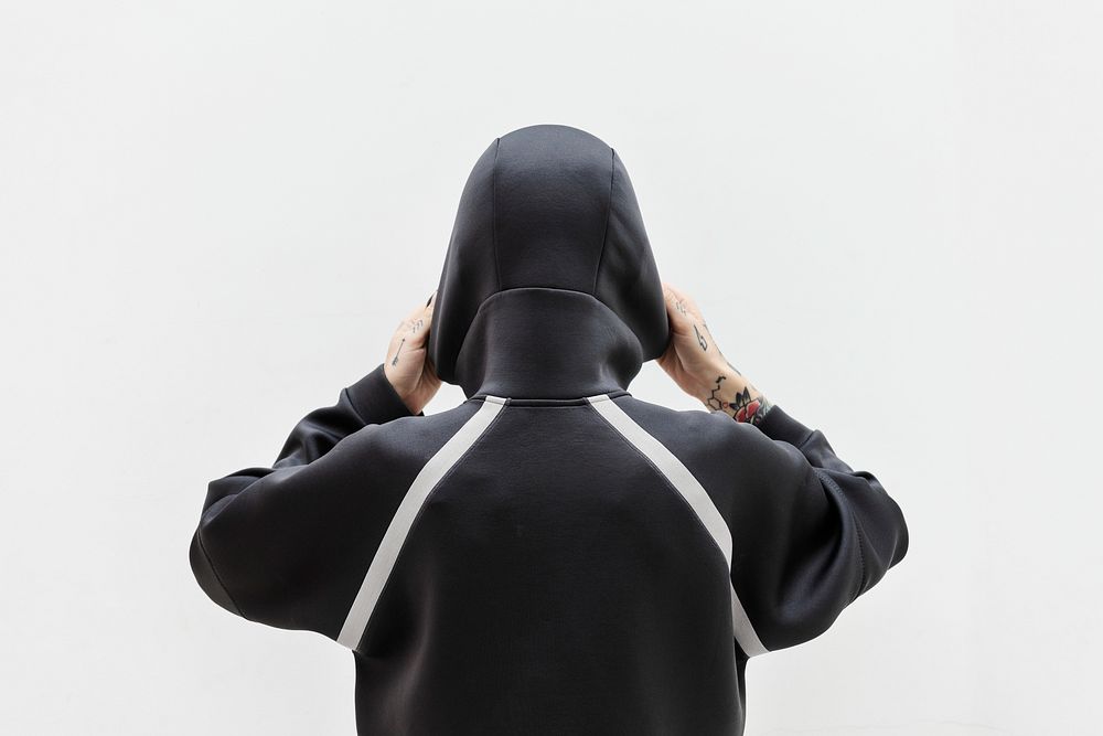 Rearview of a woman covering in a black hoodie